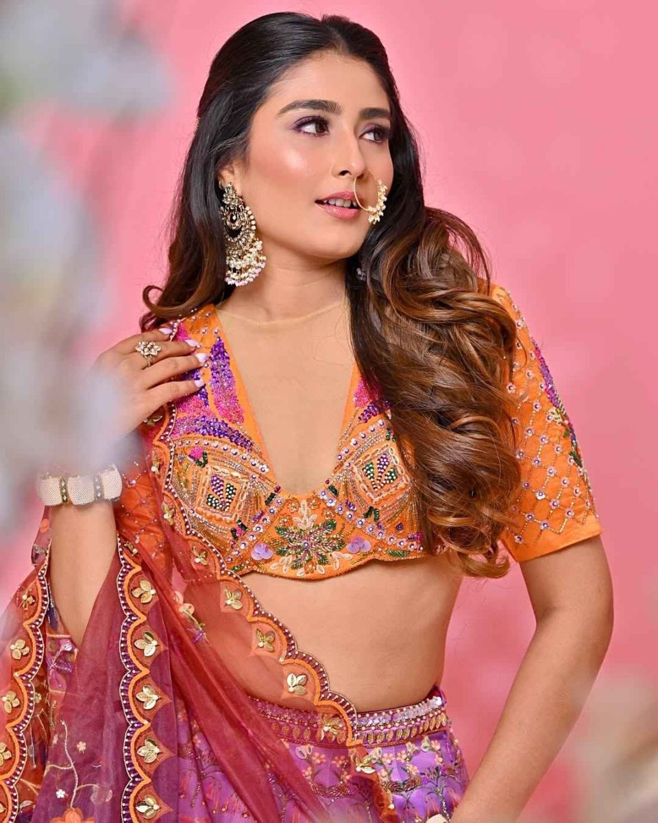 Bride in an orange and purple lehenga with nath, festive bridal look photography