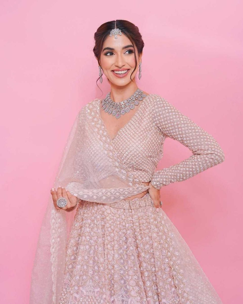 Smiling bride in a blush lehenga with diamond jewellery, bridal portrait Mumbai
